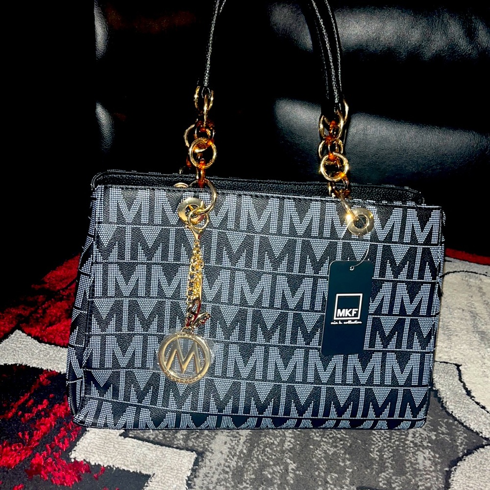Selling a brand new MKF gift purse only for $95.